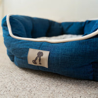 AllPetSolutions Alfie navy dog bed with a dog resting inside