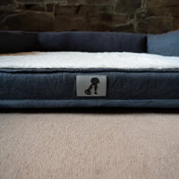 AllPetSolutions Grayson large dog bed with a dog lying on it