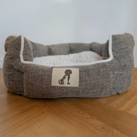 AllPetSolutions Alfie brown dog bed shown in a home setting