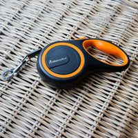 AllPetSolutions orange retractable lead shown from the side