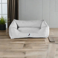 AllPetSolutions Dexter light grey waterproof dog bed with a dog lying on it