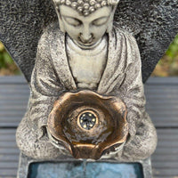 AllPetSolutions Buddha solar water feature running in a garden border